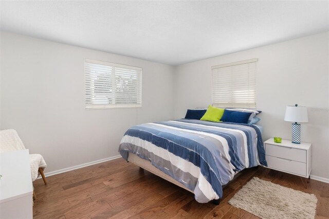 bedroom featuring wood finished floors and baseboards