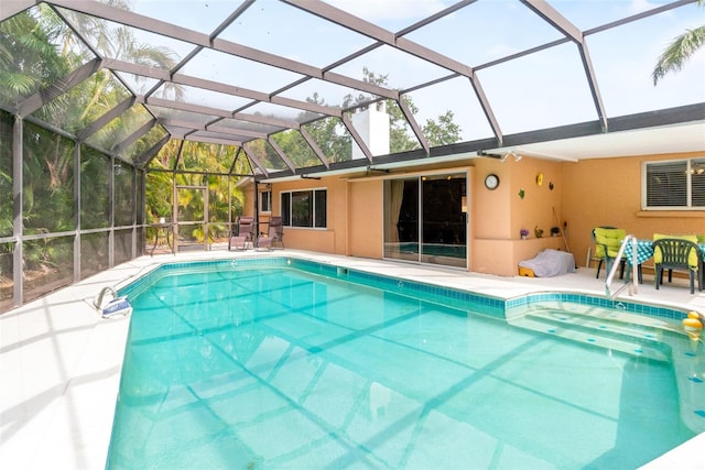 swimming pool with a patio and a lanai