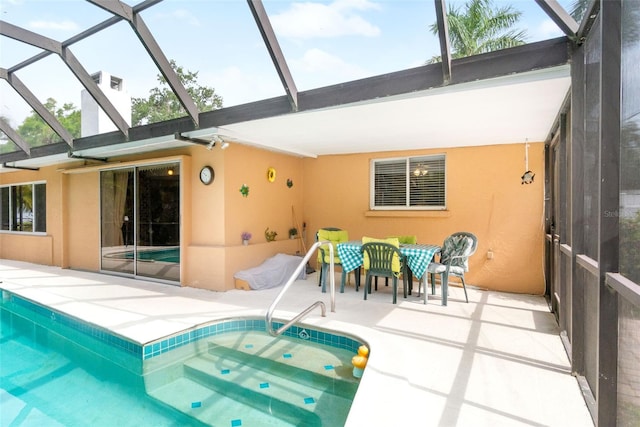 back of house featuring stucco siding, a patio, glass enclosure, and an outdoor pool