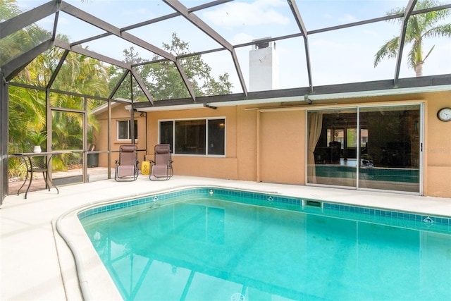 outdoor pool with a patio area and a lanai