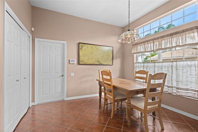 6764 Hickory Hammock Cir, Bradenton, FL 34202 - dining space featuring a chandelier, tile patterned floors, and baseboards