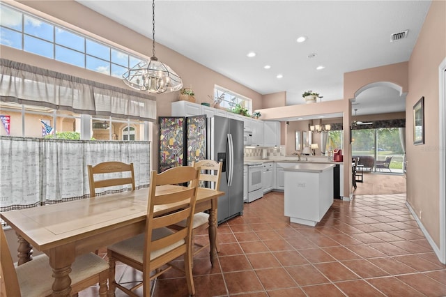 6764 Hickory Hammock Cir, Bradenton, FL 34202 - kitchen featuring a chandelier, white range with electric stovetop, stainless steel refrigerator with ice dispenser, light countertops, and recessed lighting