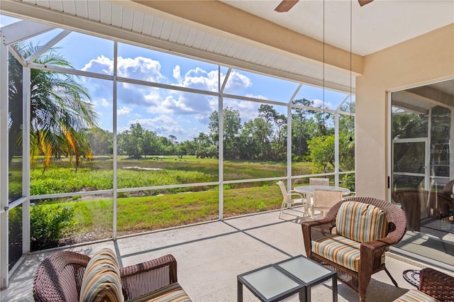 6764 Hickory Hammock Cir, Bradenton, FL 34202 - sunroom / solarium featuring a ceiling fan, view of scattered trees, and healthy amount of natural light