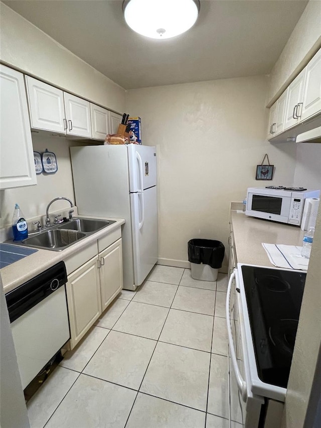 kitchen with white appliances, a sink, white cabinetry, and light countertops