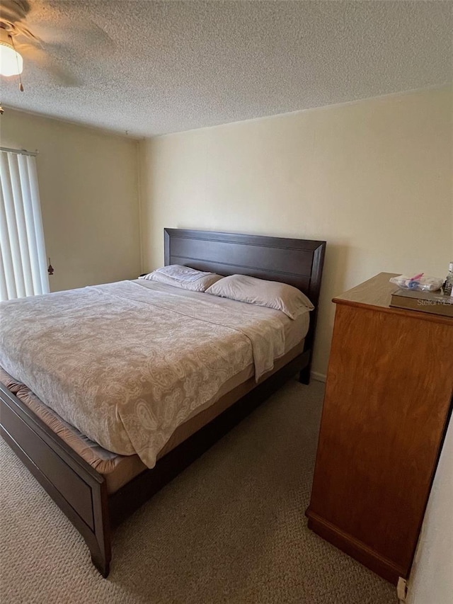 bedroom featuring carpet flooring and a textured ceiling