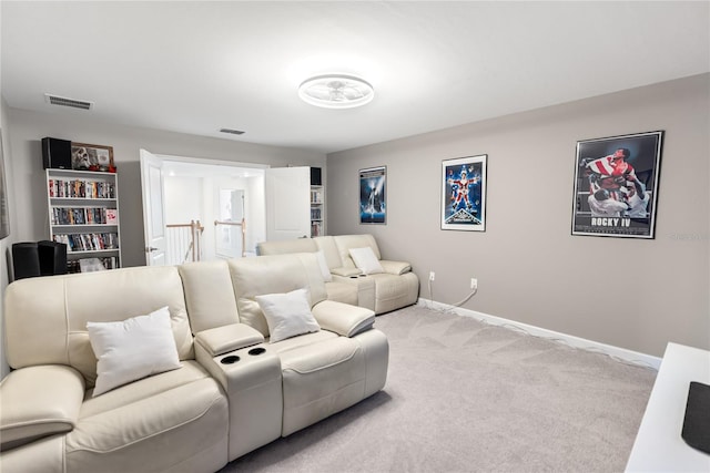 carpeted home theater room with baseboards