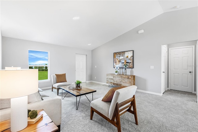 living room with vaulted ceiling, light carpet, and baseboards