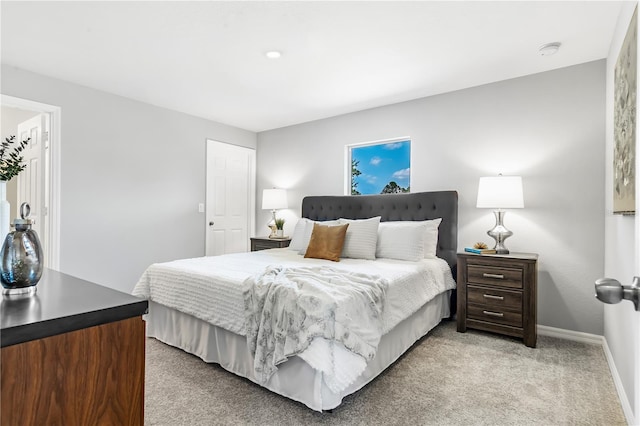 bedroom with light carpet and baseboards