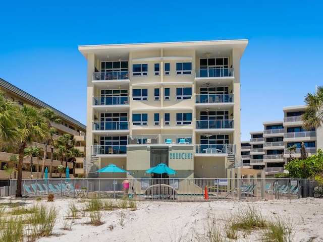 6512 Midnight Pass Rd Unit 303, Sarasota, FL 34242 - view of apartment building / complex featuring fence and cooling unit