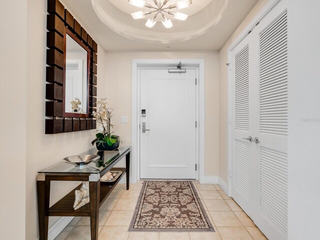6512 Midnight Pass Rd Unit 303, Sarasota, FL 34242 - doorway to outside featuring a chandelier, light tile patterned floors, and a raised ceiling