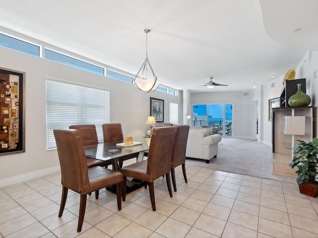 6512 Midnight Pass Rd Unit 303, Sarasota, FL 34242 - dining room featuring a ceiling fan, baseboards, light colored carpet, and light tile patterned flooring