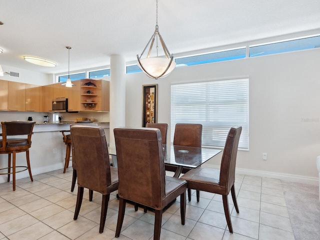 6512 Midnight Pass Rd Unit 303, Sarasota, FL 34242 - dining area featuring light tile patterned floors and baseboards