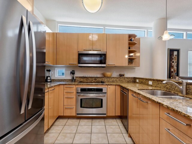 6512 Midnight Pass Rd Unit 303, Sarasota, FL 34242 - kitchen with appliances with stainless steel finishes, a sink, open shelves, hanging light fixtures, and light stone counters