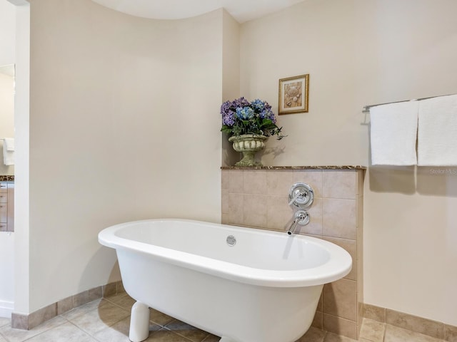 6512 Midnight Pass Rd Unit 303, Sarasota, FL 34242 - bathroom with tile patterned floors, a freestanding tub, and baseboards