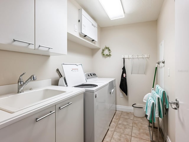 6512 Midnight Pass Rd Unit 303, Sarasota, FL 34242 - clothes washing area with cabinet space, washing machine and clothes dryer, baseboards, and light tile patterned flooring
