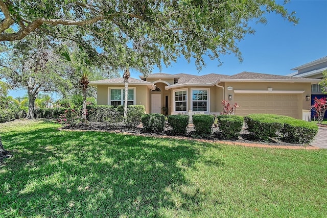 6605 38th Ln E, Sarasota, FL 34243 - single story home featuring stucco siding, a garage, and a front yard