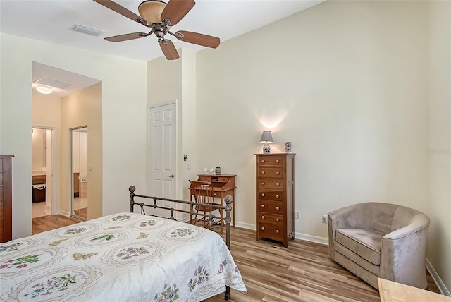 6605 38th Ln E, Sarasota, FL 34243 - bedroom featuring light wood finished floors, baseboards, ensuite bathroom, and a ceiling fan