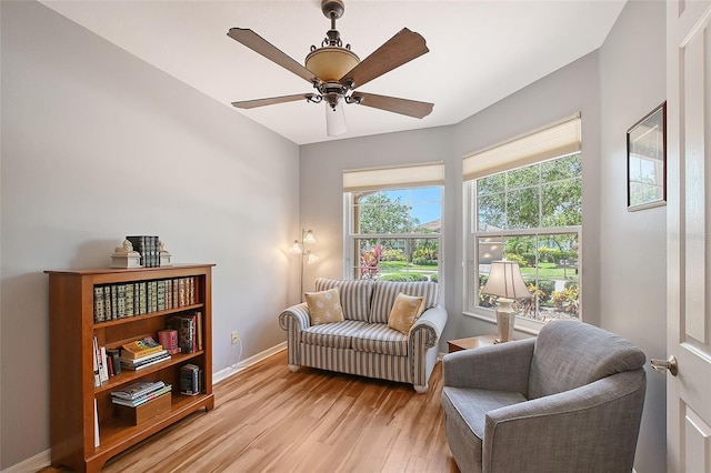 6605 38th Ln E, Sarasota, FL 34243 - sitting room featuring light wood finished floors, a ceiling fan, and baseboards
