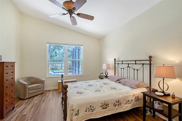 6605 38th Ln E, Sarasota, FL 34243 - bedroom with wood finished floors, lofted ceiling, a ceiling fan, and baseboards