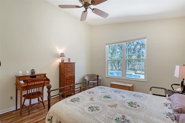 6605 38th Ln E, Sarasota, FL 34243 - bedroom with wood finished floors, baseboards, and a ceiling fan