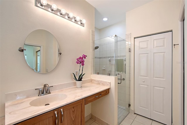 6605 38th Ln E, Sarasota, FL 34243 - bathroom with tile patterned flooring, vanity, and a shower stall