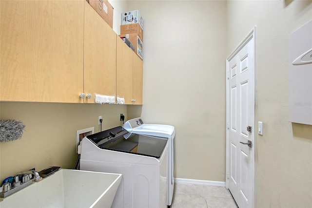 6605 38th Ln E, Sarasota, FL 34243 - washroom featuring cabinet space, washer and clothes dryer, light tile patterned floors, and baseboards