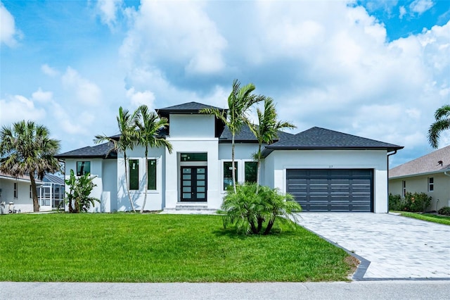 117 Marker Rd, Rotonda West, FL 33947 - contemporary home featuring french doors, a garage, stucco siding, a front lawn, and decorative driveway