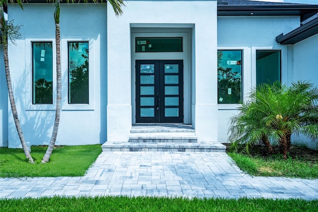 117 Marker Rd, Rotonda West, FL 33947 - entrance to property with stucco siding and french doors