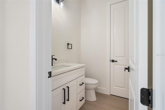 117 Marker Rd, Rotonda West, FL 33947 - half bath with vanity, toilet, and wood finished floors