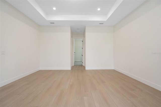 117 Marker Rd, Rotonda West, FL 33947 - spare room featuring a raised ceiling, light wood-style floors, recessed lighting, and baseboards