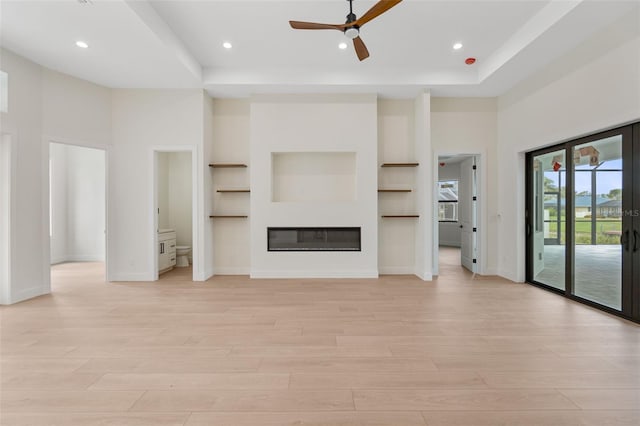 117 Marker Rd, Rotonda West, FL 33947 - unfurnished living room featuring light wood-style floors, a ceiling fan, baseboards, recessed lighting, and a glass covered fireplace