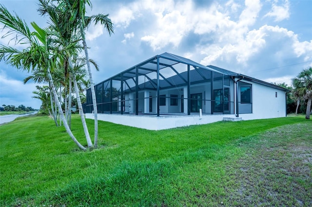 117 Marker Rd, Rotonda West, FL 33947 - rear view of house with a yard, stucco siding, and glass enclosure
