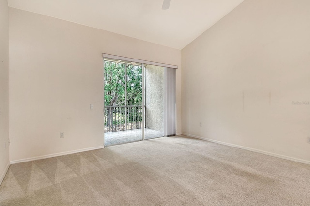 empty room featuring light carpet, baseboards, a ceiling fan, and high vaulted ceiling