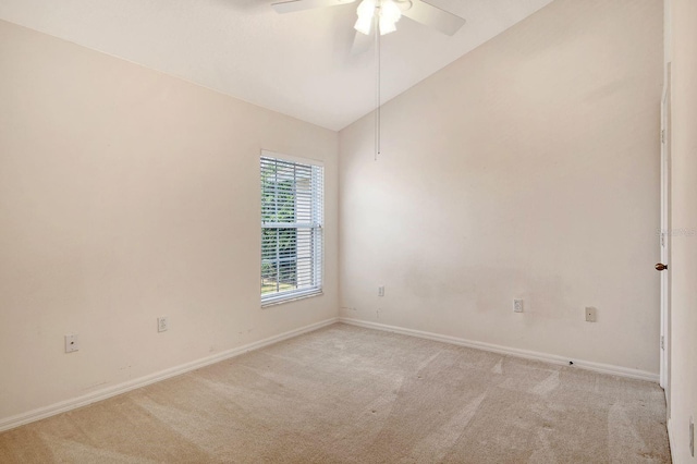 unfurnished room with light carpet, vaulted ceiling, baseboards, and ceiling fan