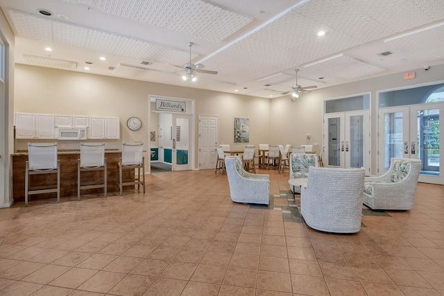 living area with french doors, a ceiling fan, light tile patterned floors, recessed lighting, and baseboards