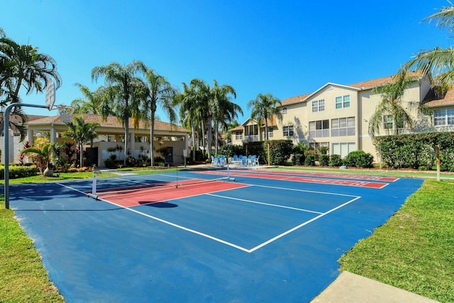 view of tennis court featuring community basketball court and a residential view