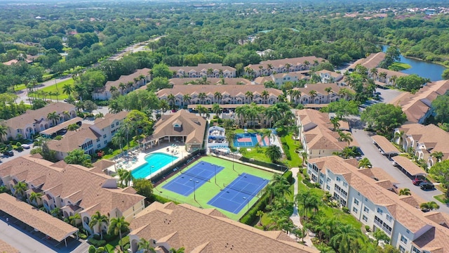 aerial overview of property's location with a pool area and nearby suburban area