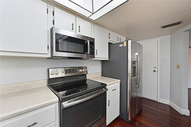2901 26th St W Unit 312, Bradenton, FL 34205 - kitchen with appliances with stainless steel finishes, dark wood-type flooring, light countertops, and white cabinets