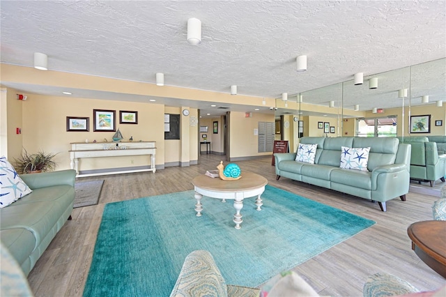 2901 26th St W Unit 312, Bradenton, FL 34205 - living room featuring wood finished floors, a textured ceiling, and baseboards