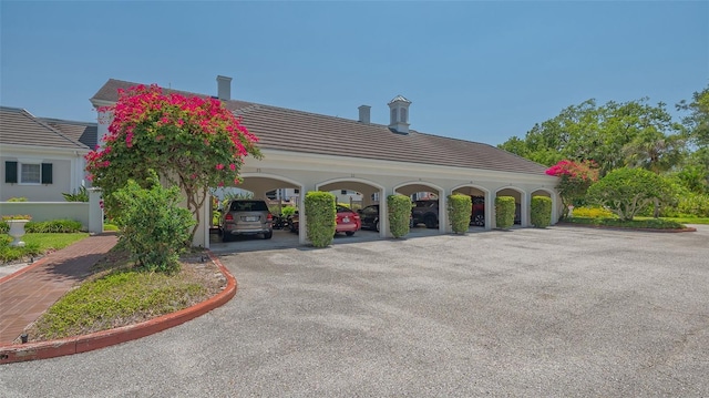 33 Bishops Court Rd Unit 118, Osprey, FL 34229 - view of side of home with a tile roof