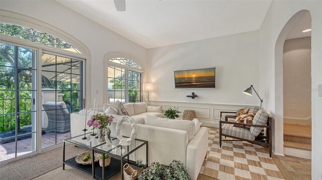 33 Bishops Court Rd Unit 118, Osprey, FL 34229 - living area with arched walkways, lofted ceiling, and ceiling fan