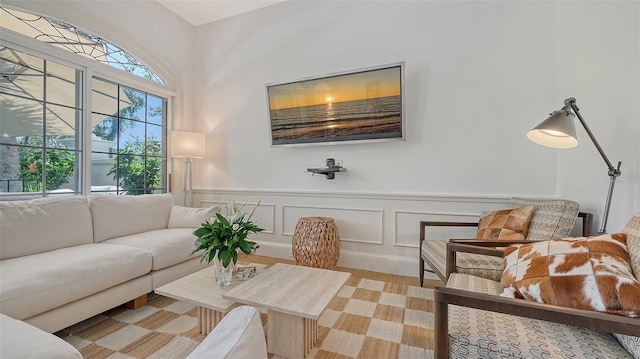 33 Bishops Court Rd Unit 118, Osprey, FL 34229 - living room featuring wainscoting, a decorative wall, and wood finished floors