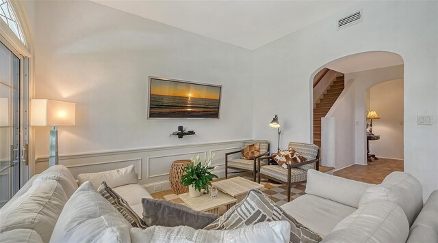 33 Bishops Court Rd Unit 118, Osprey, FL 34229 - living room featuring arched walkways and high vaulted ceiling
