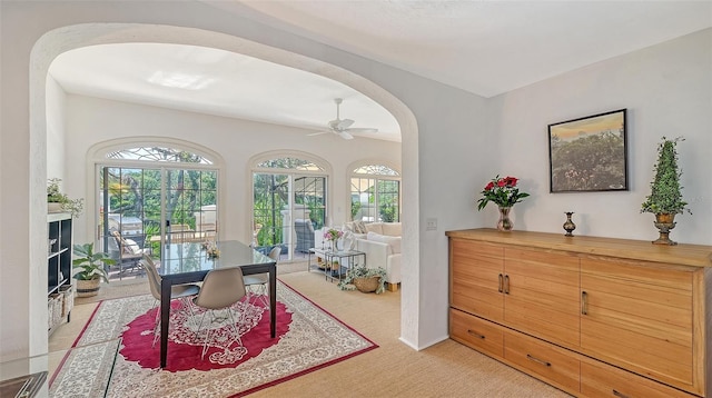 33 Bishops Court Rd Unit 118, Osprey, FL 34229 - home office featuring arched walkways, healthy amount of natural light, light carpet, and a ceiling fan