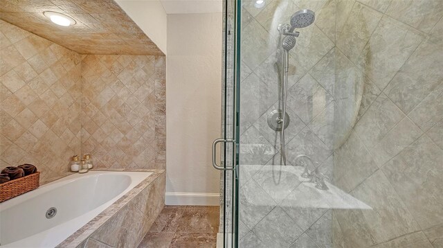 33 Bishops Court Rd Unit 118, Osprey, FL 34229 - bathroom featuring a stall shower, a jetted tub, and baseboards