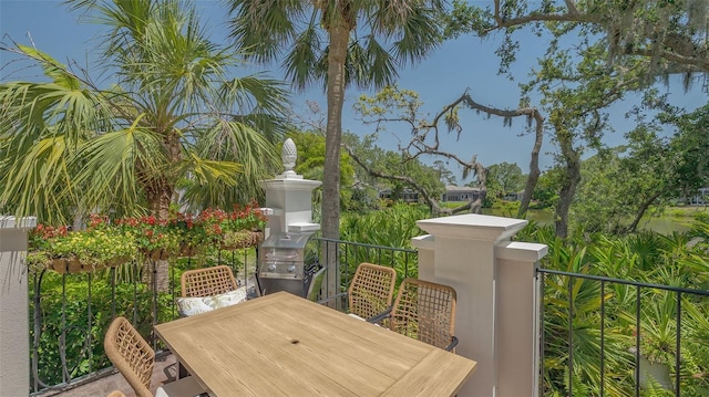 33 Bishops Court Rd Unit 118, Osprey, FL 34229 - view of patio with a balcony, outdoor dining space, and a grill