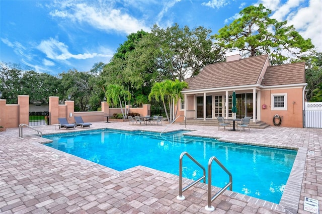 33 Bishops Court Rd Unit 118, Osprey, FL 34229 - view of pool featuring a patio, a storage structure, an outdoor structure, and a gate