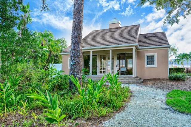 33 Bishops Court Rd Unit 118, Osprey, FL 34229 - back of property with stucco siding and a chimney