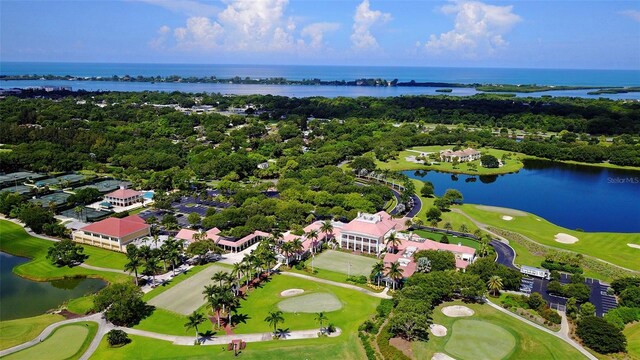 33 Bishops Court Rd Unit 118, Osprey, FL 34229 - drone / aerial view of a nearby body of water, a golf club, and a tree filled landscape