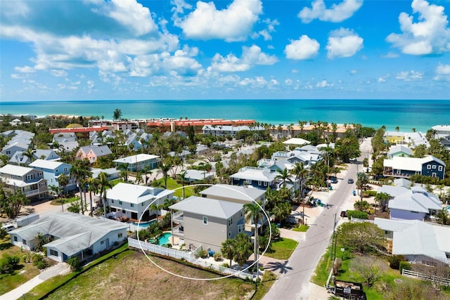aerial perspective of suburban area with a nearby body of water
